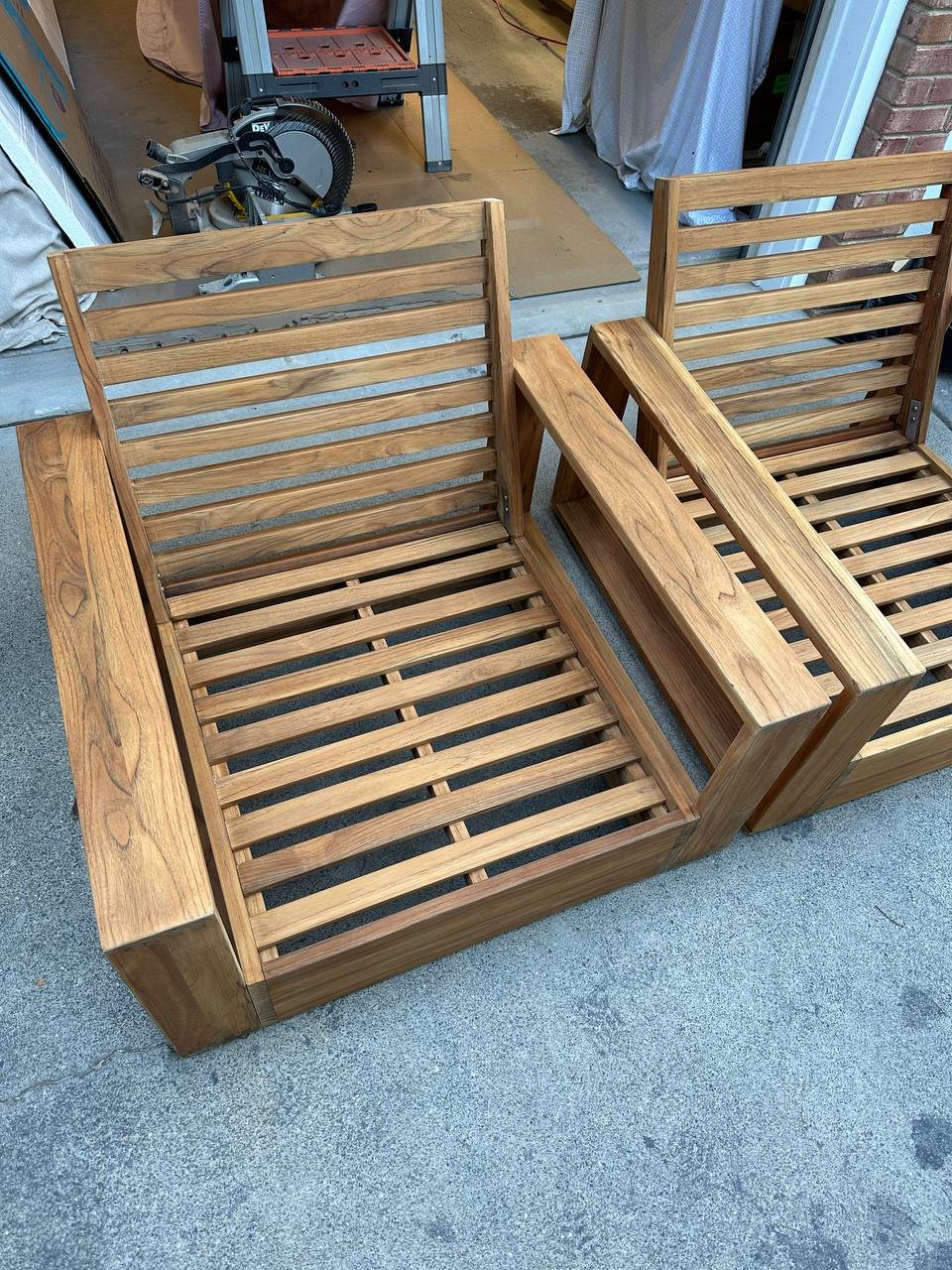 Reassembled teak outdoor chairs after cleaning and preparation