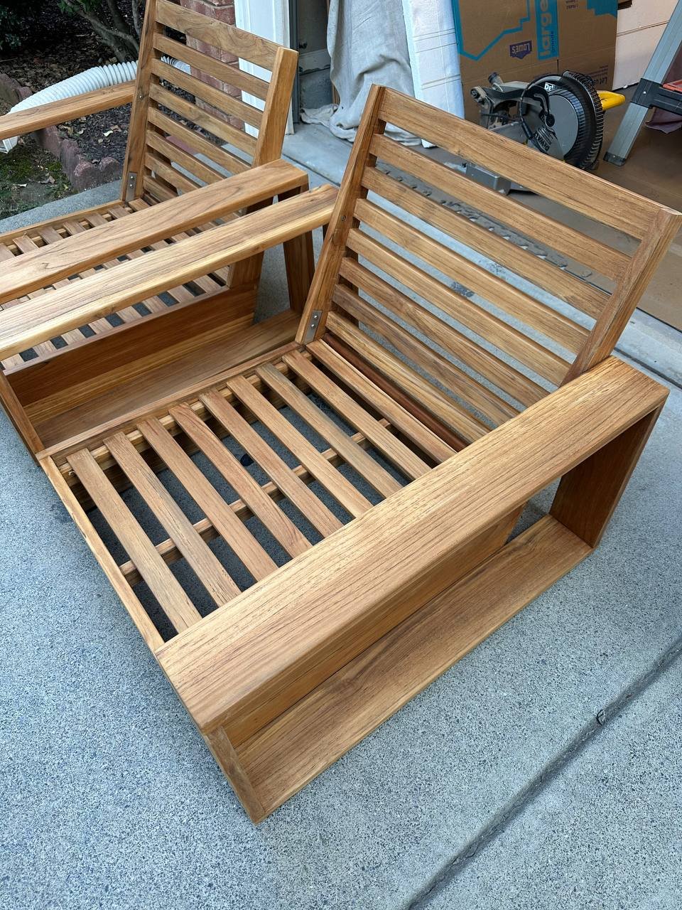 Completed teak chair restoration before outdoor use